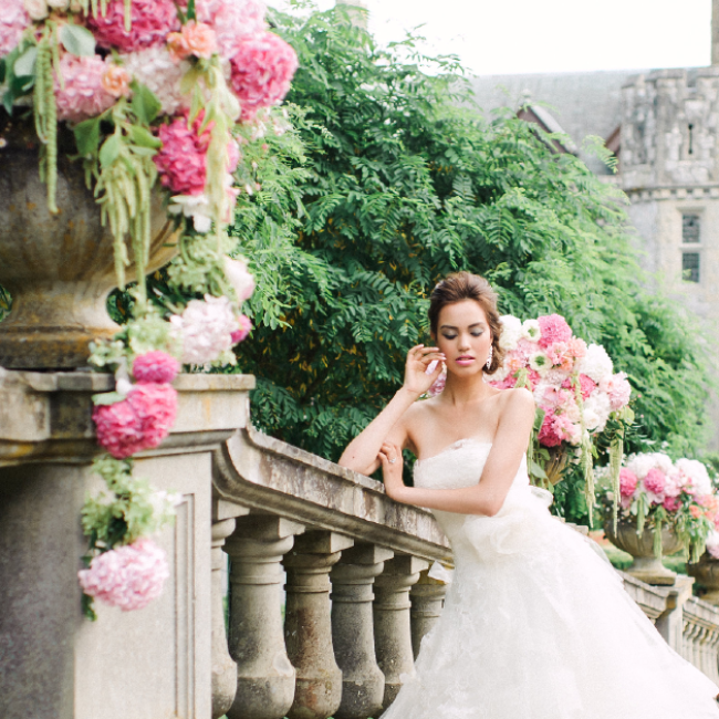 Bride in white dress in front of Hatley Castle