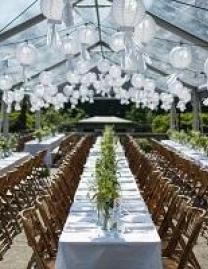 Long rows of tables set up in a white tent 