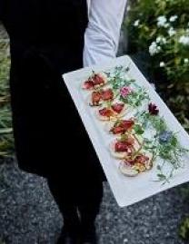 Waiter holding tray of hors d'oeuvres