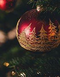 Red and gold glass ornament on Christmas tree